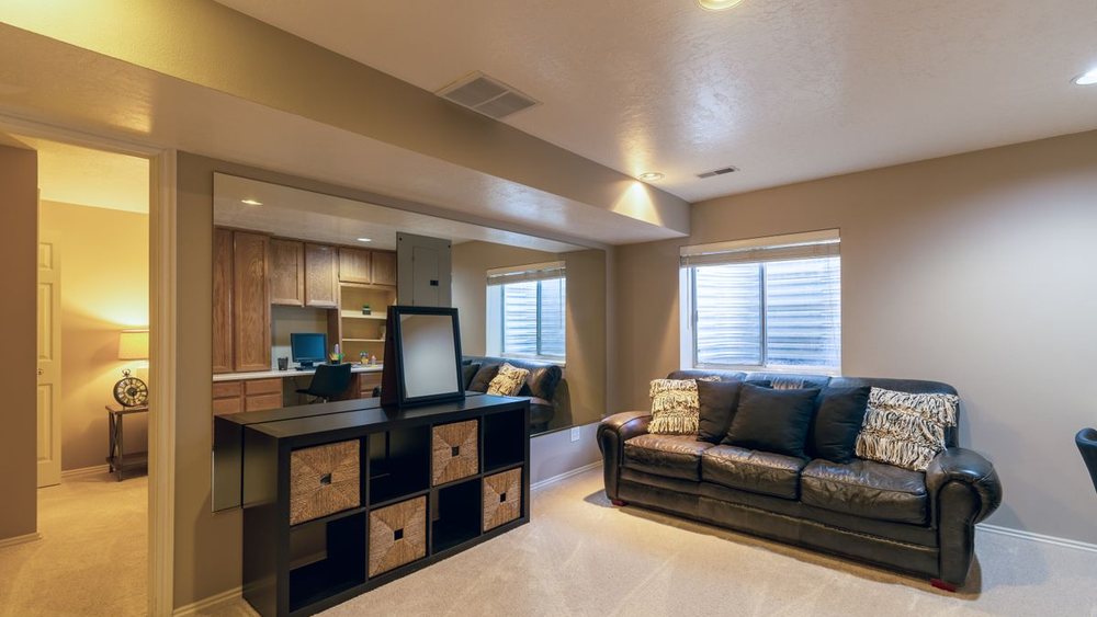 A finished lower-level suite with full-height windows