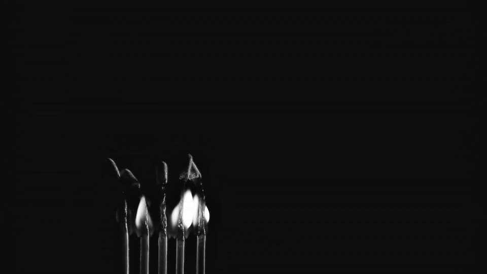 Frame 090, the last of the ninety: the match heads have burnt down to charred, curled-over hooks, and three small teardrop flames are all that is still alight. Composited over the colour field behind it.